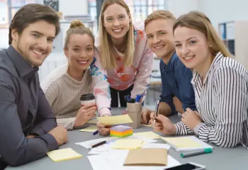 Junge Menschen sitzen zusammen und arbeiten